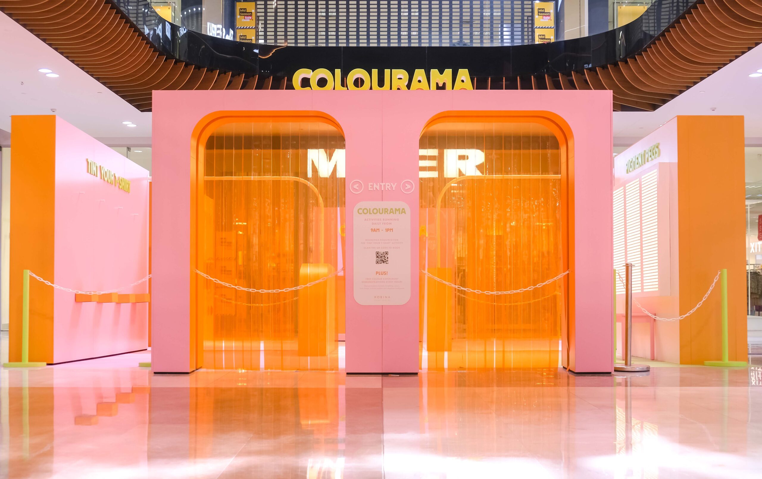 Two Pink Arches with Translucent Orange Curtains at Entry of Activation Set.