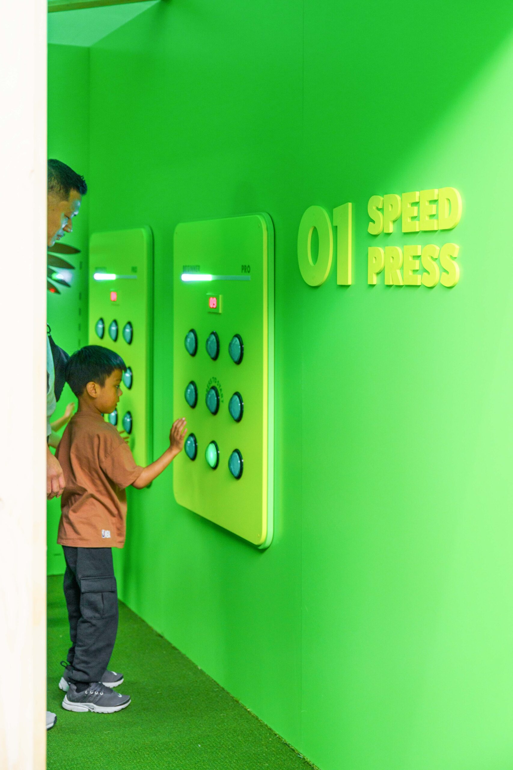 Green Interactive Wall with Button Press Game for Kids.